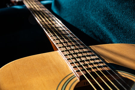 acoustic guitar, six-string, made of light wood, close-up. lifestyle, bottom view