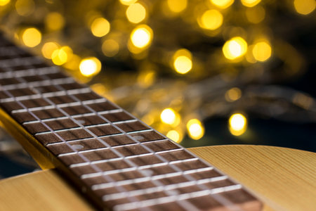 ukulele on a blurred background with highlights. nylon strings, close-up, details, bokeh