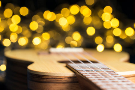 ukulele on a blurred background with highlights. nylon strings, close-up, details, bokehの写真素材