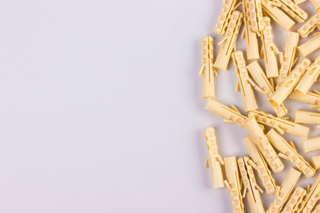 construction yellow dowels for fasteners. on a white background with space for text or object