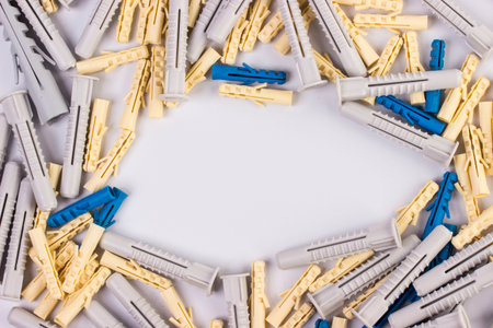 construction yellow and grey dowels for fasteners. on a white background with space for text or subjectの写真素材