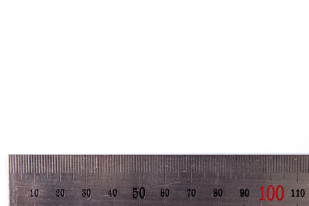 metal ruler on a white background. taken in close-up with space for text or theme, advertising