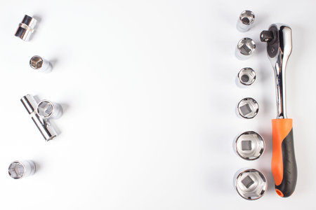Socket wrench with socket heads on a white background. taken in close-up with space for text or...