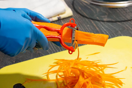 quick and beautiful carrot slicing in the kitchen  taken in close-up with space for text, subject,...