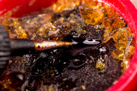 the tip of the soldering iron in working with smoke. taken in close-up with a place for text with a...