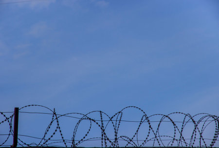 dreams of freedom. the will to freedom. free sky. barbed wire on a blue sky background.