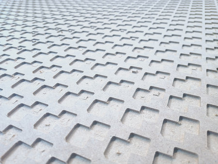 a texture with indented rectangles of irregular shape in gray. vertical view. close-up