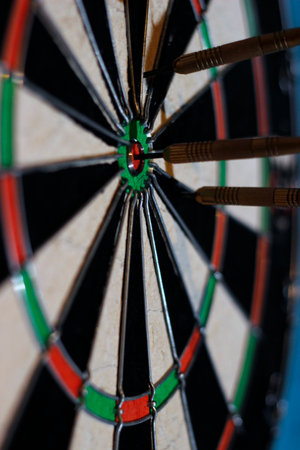 darts with darts hitting the target taken in close-up