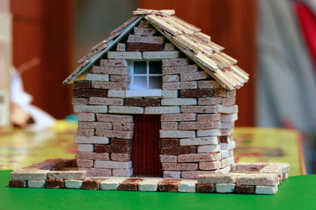 a children's construction kit made of bricks. made by a child. taken in close-up in light colors