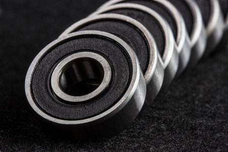 industrial bearings. bearings for roller skates and baby strollers in close-up on a black background. space for text. roller skate service. repair shop.