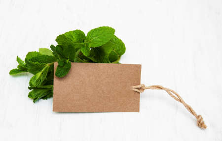 Fresh mint with label on a old white wooden backgroundの写真素材