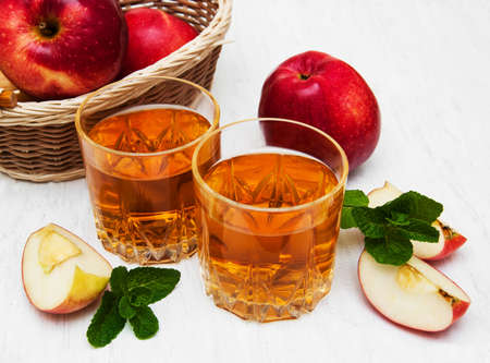 Glasses of apple juice and fresh red appleの写真素材