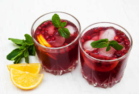 Glasses with cranberry coctail on a old white wooden backgroundの写真素材