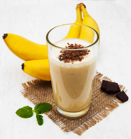 Banana smoothie with chocolate on a old white wooden backgroundの写真素材