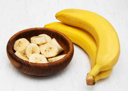 Fresh banana in a bowl on a old white wooden backgroundの写真素材