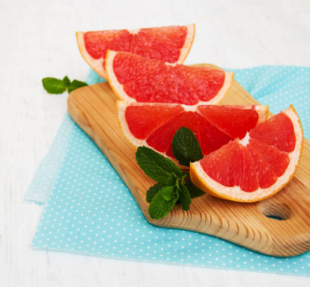 Grapefruit with mint on a old white wooden backgroundの写真素材