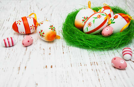 Easter eggs in a nest on a old wooden background