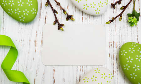 Easter greeting card with easter eggs on a old wooden background