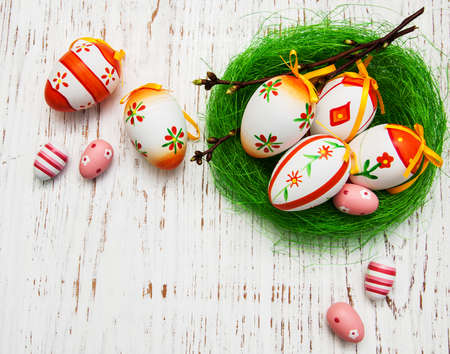 Easter eggs in a nest on a old wooden backgroundの写真素材