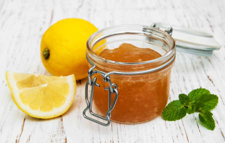 lemon jam and fresh lemons on a wooden backgroundの写真素材