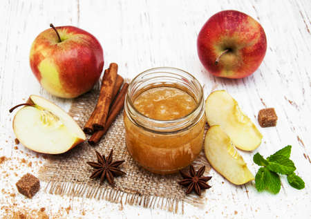 Apple jam and fresh apple on a wooden backgroundの写真素材