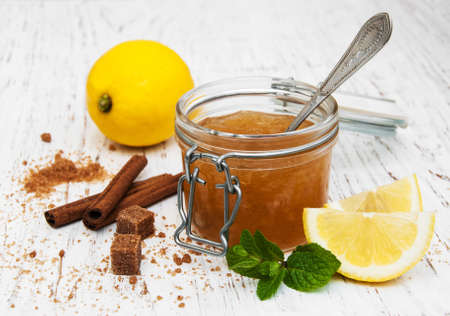 lemon jam and fresh lemons on a wooden backgroundの写真素材