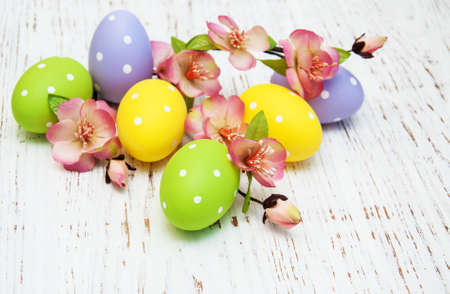 Easter eggs with flowers on a old wooden backgroundの写真素材
