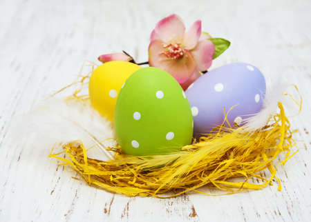Easter eggs in a nest on a old wooden backgroundの写真素材
