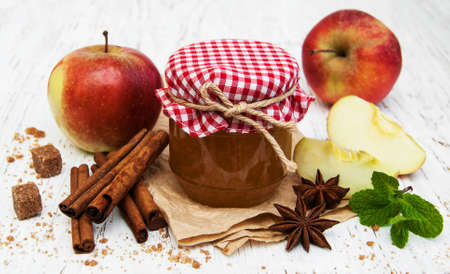 Apple jam and fresh apple on a wooden backgroundの写真素材