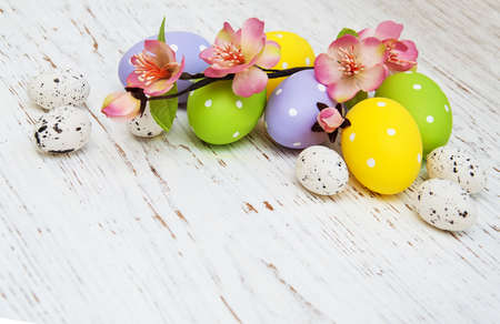 Easter eggs with flowers on a old wooden backgroundの写真素材