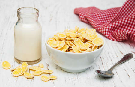 Cornflakes with milk  on a wooden background