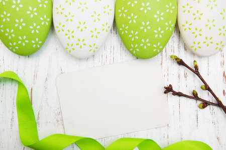 Easter greeting card with easter eggs on a old wooden backgroundの写真素材