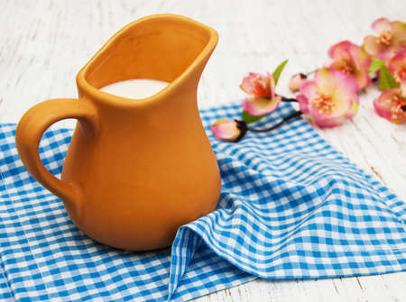 Jug with fresh milk and spring flowersの写真素材