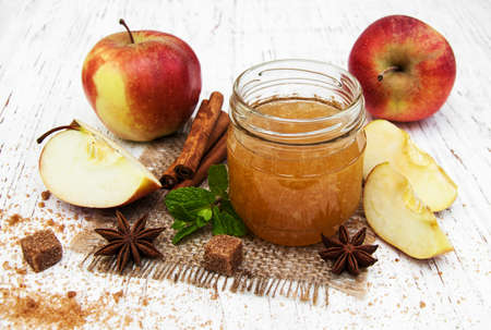 Apple jam and fresh apple on a wooden backgroundの写真素材