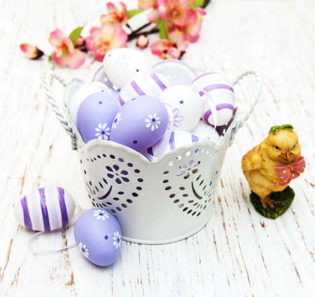 Easter eggs with flowers on a old wooden backgroundの写真素材