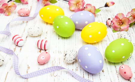Easter eggs with flowers on a old wooden backgroundの写真素材