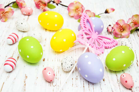 Easter eggs with flowers on a old wooden backgroundの写真素材
