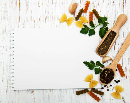 open recipe book with blank page with pasta and spicesの写真素材