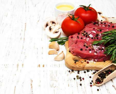 fillet of beef and ingredients on a old wooden backgroundの写真素材