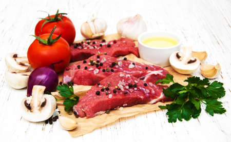 fillet of beef and ingredients on a old wooden backgroundの写真素材