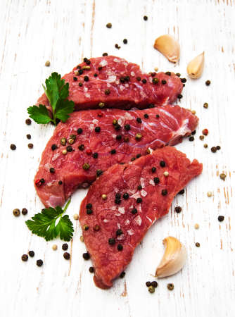 fillet of beef and ingredients on a old wooden backgroundの写真素材