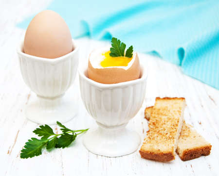 boiled eggs for breakfast on a old wooden tableの写真素材