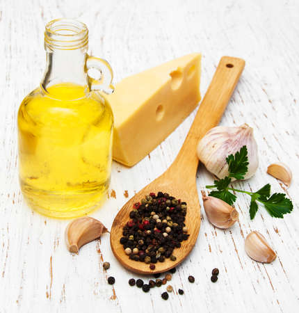 Olive oil, garlic and cheese on a old wooden backgroundの写真素材