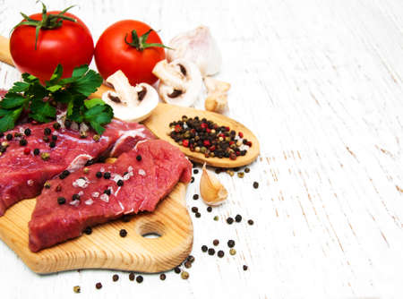 fillet of beef and ingredients on a old wooden backgroundの写真素材