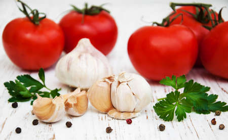 garlic and tomato on a old wooden background