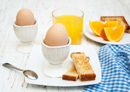 boiled eggs for breakfast on a old wooden tableの写真素材