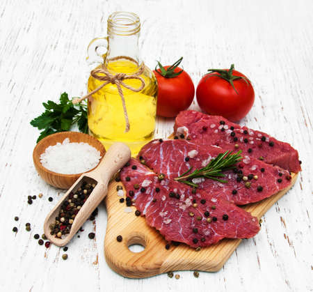 fillet of beef and ingredients on a old wooden backgroundの写真素材