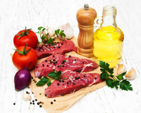 fillet of beef and ingredients on a old wooden backgroundの写真素材