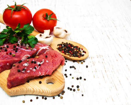 fillet of beef and ingredients on a old wooden backgroundの写真素材
