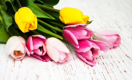 bouquet of pink and yellow tulips  on a wooden backgroundの写真素材